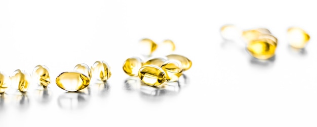 Witamina D i złote tabletki Omega 3 dla zdrowej diety odżywianie olej rybny suplement diety kapsułki pigułka opieka zdrowotna i medycyna jako tło farmacji