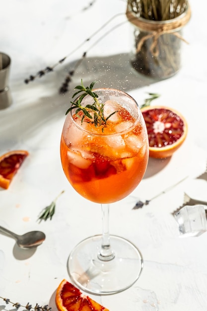 Włoski koktajl Aperol Spritz z czerwonymi czerwonymi pomarańczami, gorzkim wytrawnym białym winem, skórką sodową i lodem Letni napój