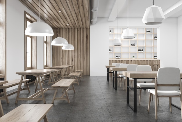 Wnętrze drewnianej i białej ściany z betonową podłogą, drewniane stoły z ławkami i krzesłami.