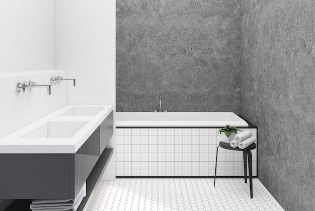 Wnętrze łazienki z betonowymi ścianami, dużą kątową kąpielą i białym podwójnym zlewem.