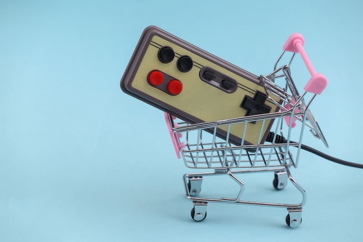 Zdjęcie wózek na zakupy z retro gamepadem na niebieskim tle. atrybuty retro lat 80.