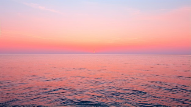 Wschód słońca nad spokojnym horyzontem oceanu w odcieniach pomarańczy i różu