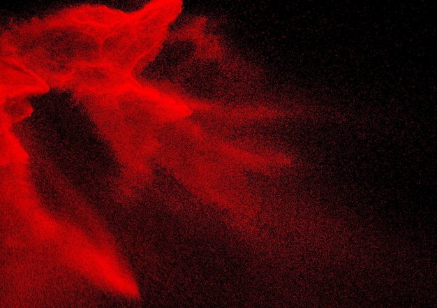 Wybuch cząstek czerwonego pyłu na czarnym tle Powitalny czerwony proszek