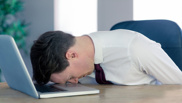 Wyczerpana biznesmena dosypiania głowa na laptopie
