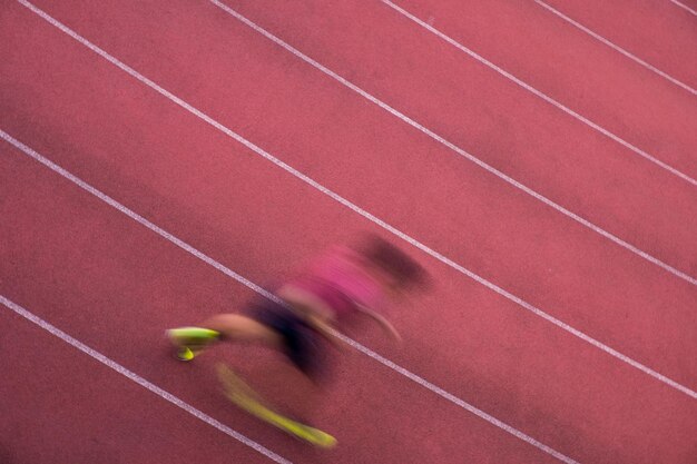 Zdjęcie wysoki kąt niewyraźnego ruchu sportowca biegającego na torze