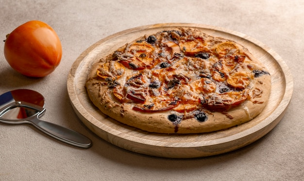 Zdjęcie wysoki kąt pysznej pizzy z persymoną
