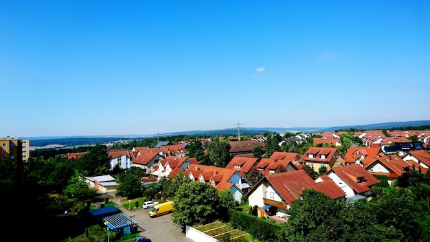 Wysoki kąt widoku dzielnicy mieszkalnej na tle jasnego niebieskiego nieba