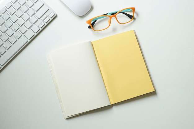 Wysoki kąt widoku otwartej pustej książki przez okulary na stole