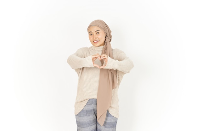 Wyświetlono znak serca lub miłości pięknej azjatyckiej kobiety noszącej hidżab na białym tle