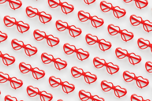 Wzór wykonany z czerwonych okularów przeciwsłonecznych w kształcie serca na pastelowym tle Koncepcja Walentynek