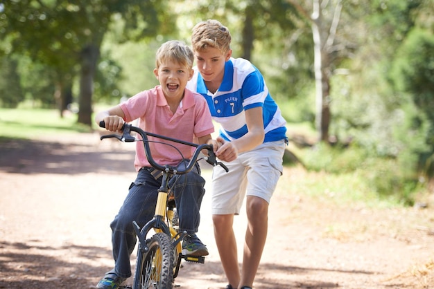 Zabawa z rowerami Młodzi chłopcy jeżdżący na rowerach na zewnątrz