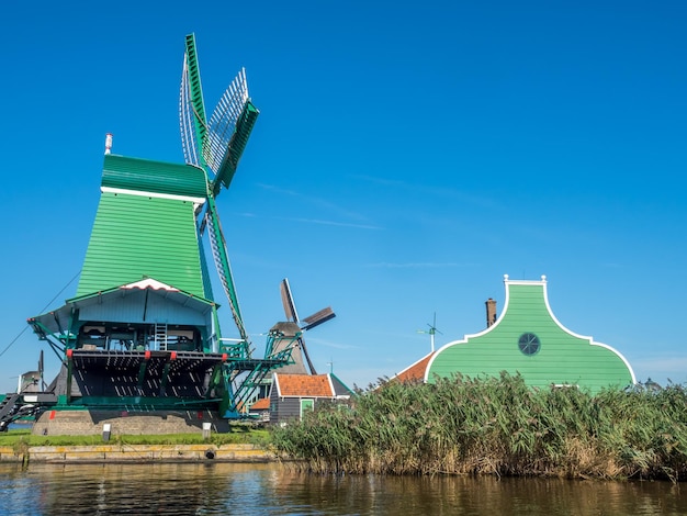 Zabytkowy klasyczny wiatrak o nazwie De Gekroonde Poelenburg („koronowany poelenburg”) w Zaan Schans w Holandii