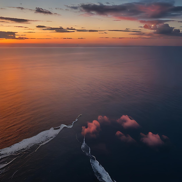 zachód słońca nad oceanem z zachodem słońca na tle