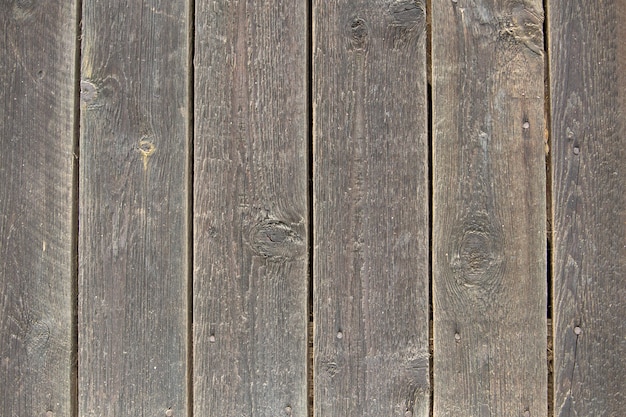 Zakończenie naturalny stary rocznik wietrzał popielatego brązu niepomalowanego litego drewnianego ogrodzenie lub bramę z desek i desek.