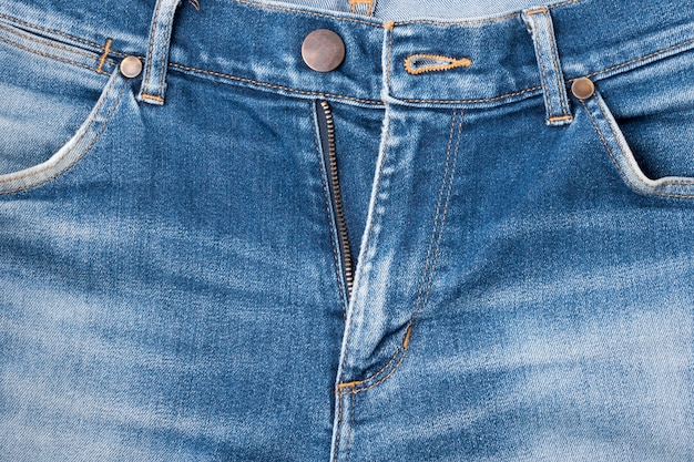 Zakończenie niebiescy dżinsy spodnia, drelichowy cajgu tło.
