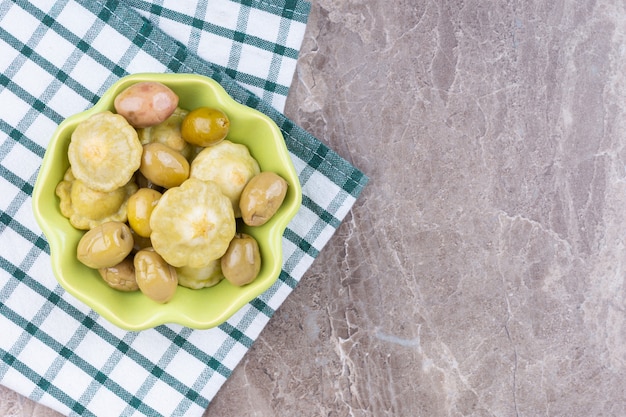 Zakonserwowany Pattypan Squash I Oliwka W Misce Na Ręczniku, Na Marmurze.