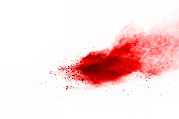 Zdjęcie zamrozić ruch czerwony proszek wybuchu, na białym tle.