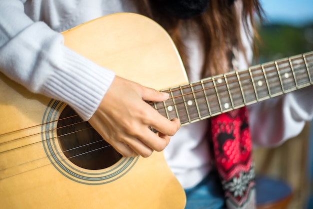 Zamyka up palec kobieta gitarzysta bawić się gitarę