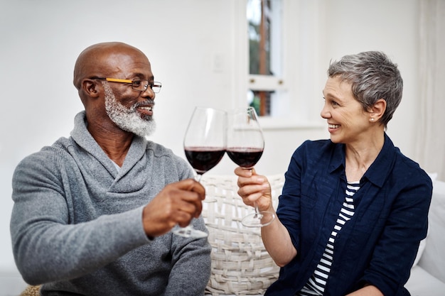 Zawsze świętowaliśmy naszą miłość Ujęcie czułej pary seniorów delektującej się winem w domu