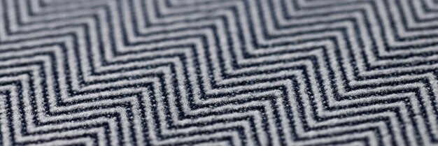 Zbliżenie czarno-szara tkanina w jodełkę tekstura tło wzór gładkiej tkaniny