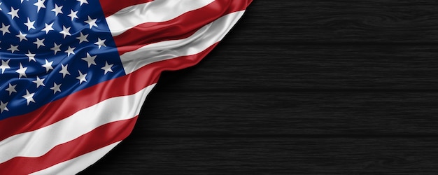 Zbliżenie flagi Stanów Zjednoczonych Ameryki na czarnym drewnianym tle renderowania 3D
