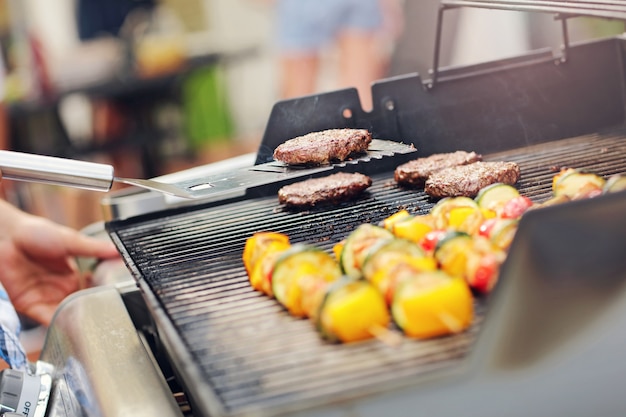 Zbliżenie grillowanych szaszłyków i hamburgerów na ruszcie