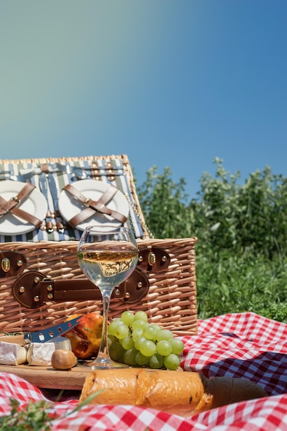 Zbliżenie kosz piknikowy z napojami i jedzeniem na trawie