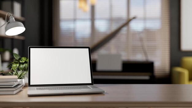 Zbliżenie laptopa z białym makietą ekranu na drewnianym stole w współczesnym salonie