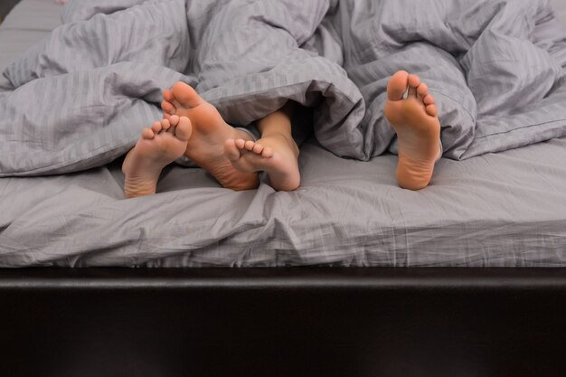 Zbliżenie Na Kobiece I Męskie Stopy Pod Szarym Kocem W Nowoczesnym Stylowym łóżku