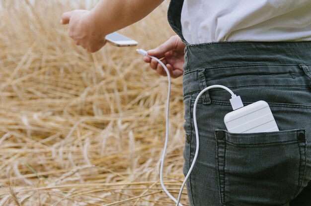 Zbliżenie na ładowanie telefonu z trzymanego w rękach power banku