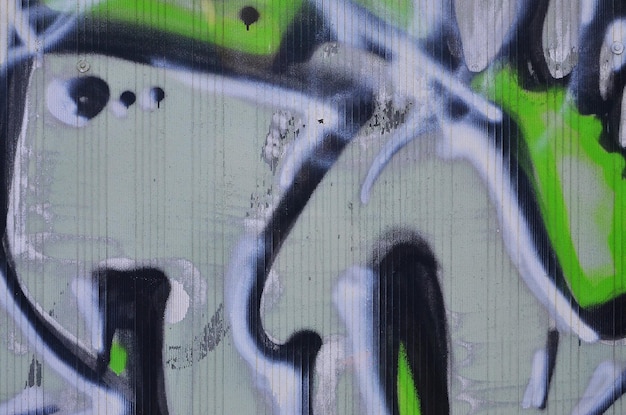 Zbliżenie na szczegóły rysunku graffiti Obraz tła na temat sztuki ulicznej i wandalizmu Tekstura ściany pomalowana farbami w aerozolu