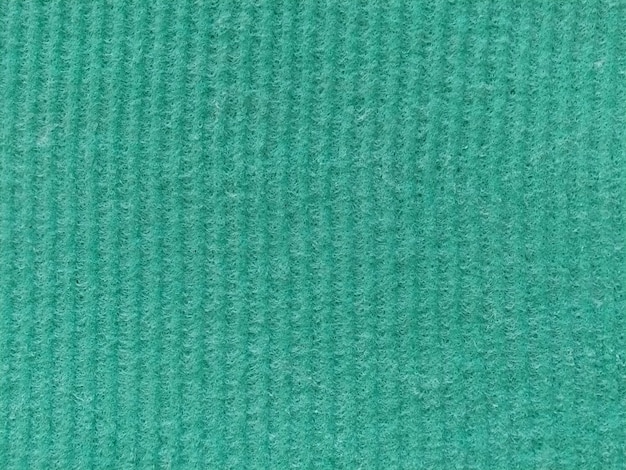 Zbliżenie pasiastej tkaniny z podniesionym nadrukiem Pionowe paski na zielonej mikrofibrze lub gąbce