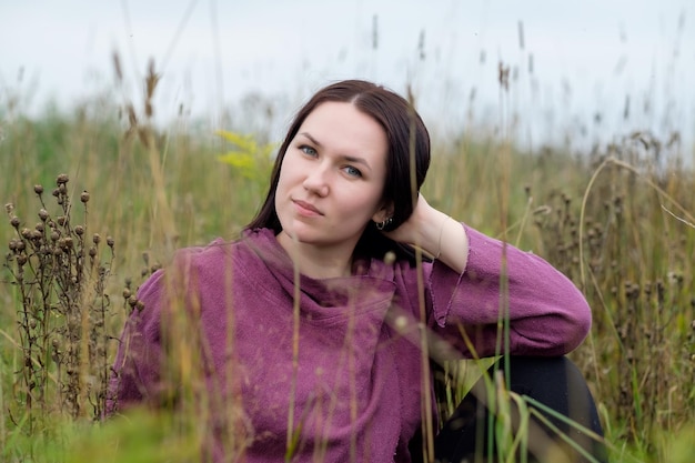 Zbliżenie portret atrakcyjnej brunetki kobiety na jesiennym kwiatowym polu