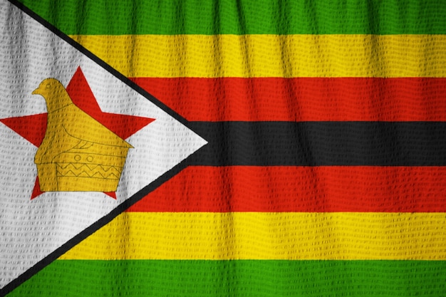 Zdjęcie zbliżenie potargane flaga zimbabwe, flaga zimbabwe wiejący wiatr