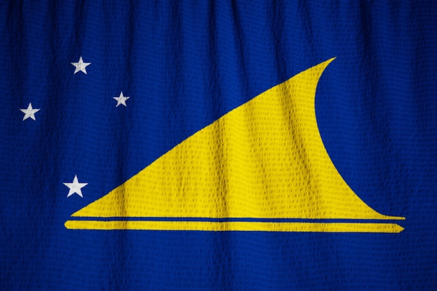 Zbliżenie potargane flagi Tokelau, flaga Tokelau wieje wiatr