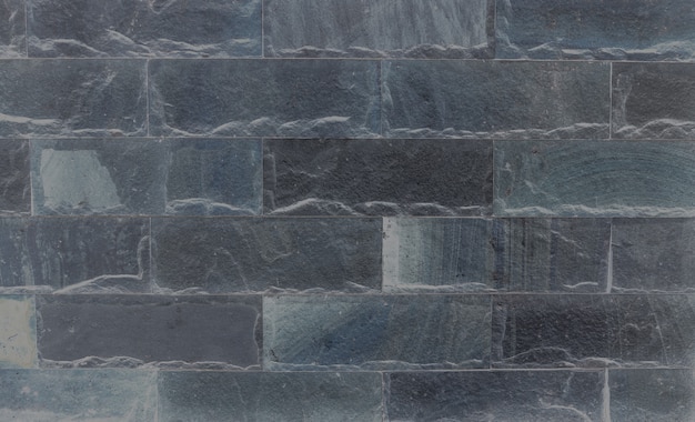 Zbliżenie powierzchni ceglany wzór przy starym czerni kamienia ściana z cegieł textured tło