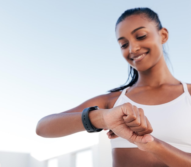 Zbliżenie ręki szczupłej młodej kobiety dostosowującej swój smartwatch przed treningiem x9