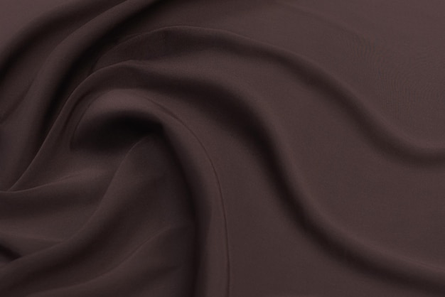 Zbliżenie tekstury naturalnej beżowej tkaniny lub tkaniny w brązowym kolorze