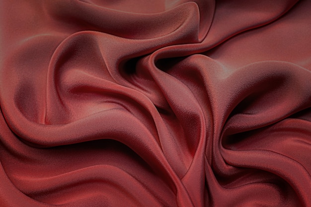 Zbliżenie tekstury naturalnej czerwonej, karmazynowej lub różowej tkaniny. Tekstura tkaniny z naturalnej bawełny, jedwabiu lub wełny lub lnianego materiału tekstylnego. Czerwone i pomarańczowe płótno tło.