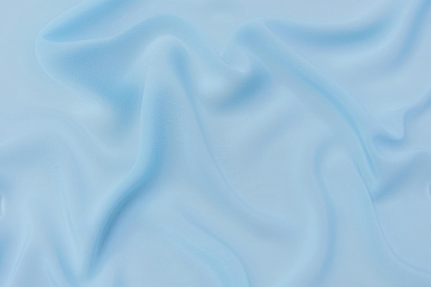 Zbliżenie tekstury naturalnej niebieskiej tkaniny lub tkaniny w tym samym kolorze Tekstura tkaniny z naturalnego bawełnianego jedwabiu lub wełny lub materiału tekstylnego lnianego Niebieskie tło płótna