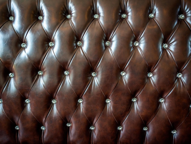 Zbliżenie vintage brązowy skórzany guzik sofa tekstura