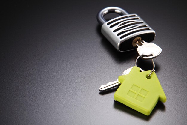Zdjęcie zbliżenie zamka i klucza do domu na szarym tle