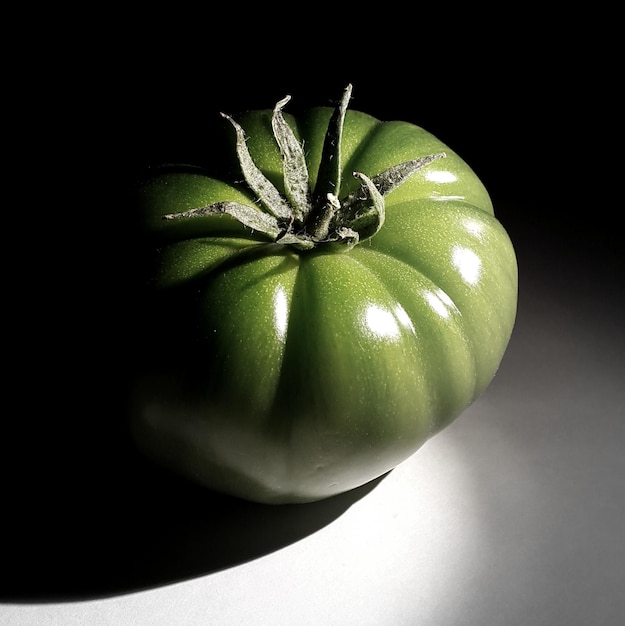 Zdjęcie zbliżony plan zielonego pomidora na stole