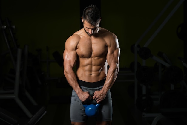 Zdrowy Mężczyzna Ćwiczący Z Czajnikowym Dzwonkiem I Napinającym Mięśnie Mięśni Atletyczny Kulturysta Ćwiczenia Modelu Fitness