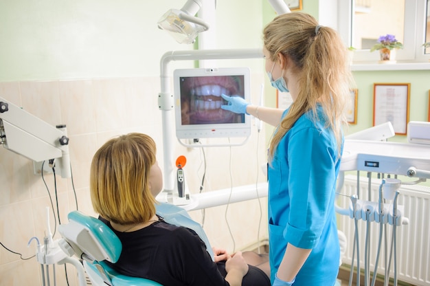 Żeński Dentysta Pokazuje Fotografię Zęby Na Komputerze Pacjent