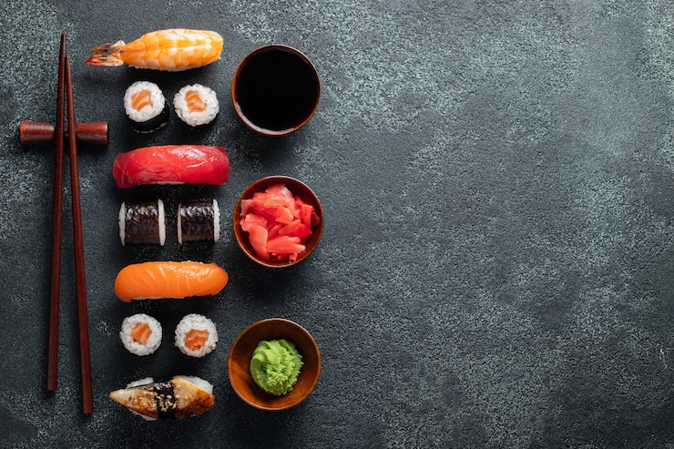 Zdjęcie zestaw sushi i maki na kamiennym stole.