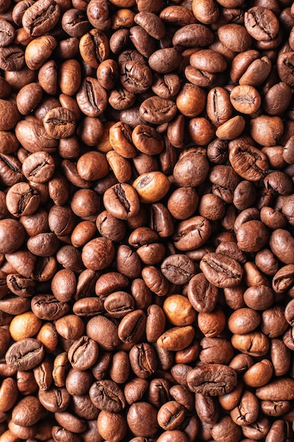 Ziarna brązowej kawy tekstury tła Zbliżenie Orientacja pionowa
