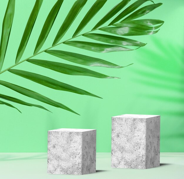 Zielone tło z szarymi betonowymi kostkami i etapem prezentacji produktu z liści palmowych