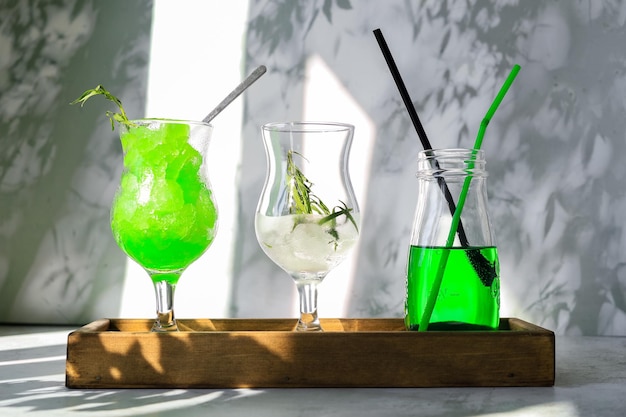 Zielony kruszony lód, szklanka z lodem do przygotowania zimnego napoju i zielona lemoniada do letniego koktajlu