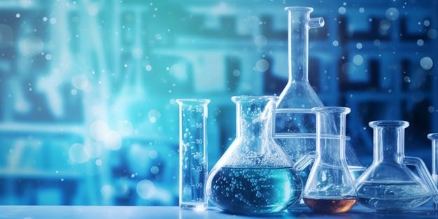 zlewka i kolba w laboratorium naukowym o strukturze chemicznej niebieskim tle transparentu